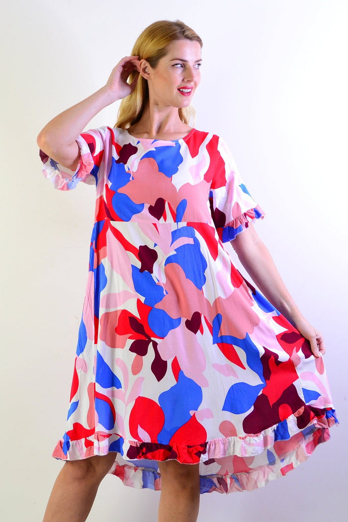 Multicolour abstract summer dress tunic from New U Collection with vibrant patterns and flowing fabric, displayed on a hanger.