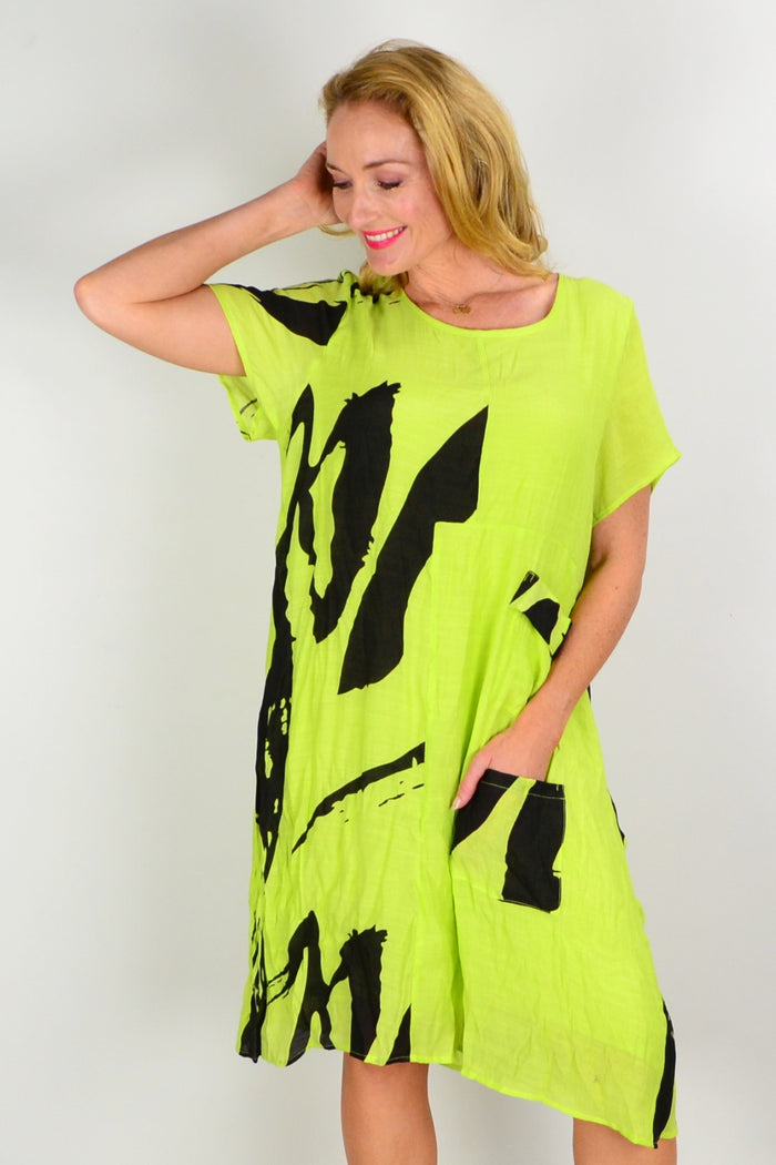 Wishstone Noosa Lime Tunic Dress displayed on a hanger, showcasing its vibrant color and relaxed fit design.