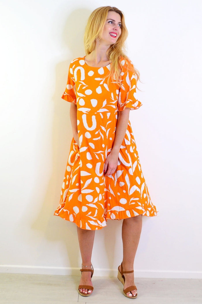Orange and white spotted summer dress by New U Collection, featuring a stylish tunic design with a vibrant print.