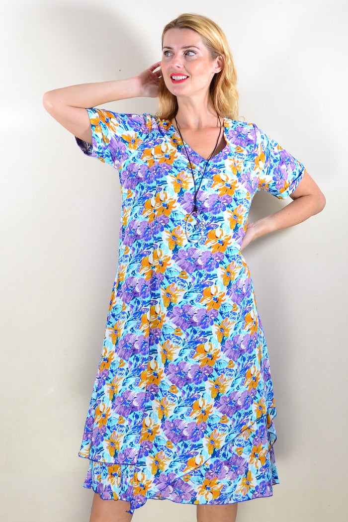 Purple mustard floral tunic dress by Missy Q featuring long sleeves and a relaxed fit, displayed on a hanger.