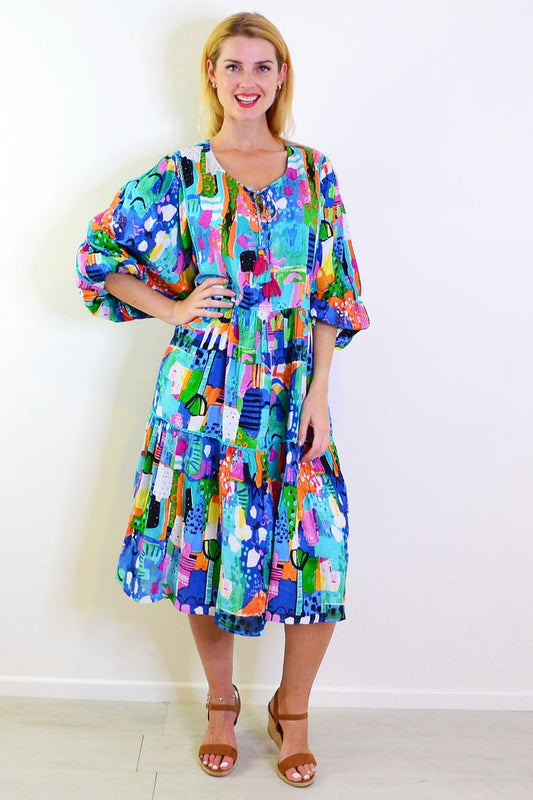 Orientique Alanya Boho Tunic Dress with vibrant patterns and relaxed fit, displayed on a hanger against a neutral background.