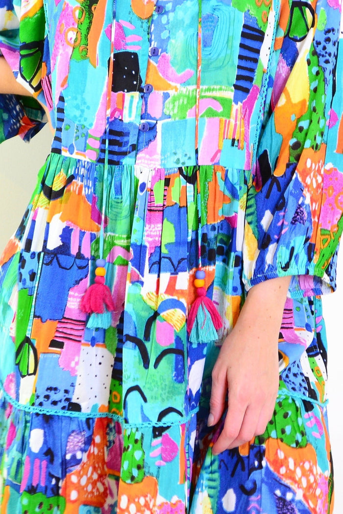 Orientique Alanya Boho Tunic Dress displayed on a hanger, featuring vibrant patterns and flowing fabric perfect for casual wear.