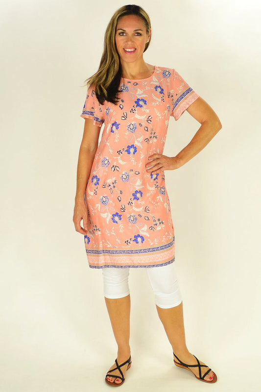 Apricot floral MSTYLE tunic with a flowy design and long sleeves, displayed on a hanger against a neutral background.