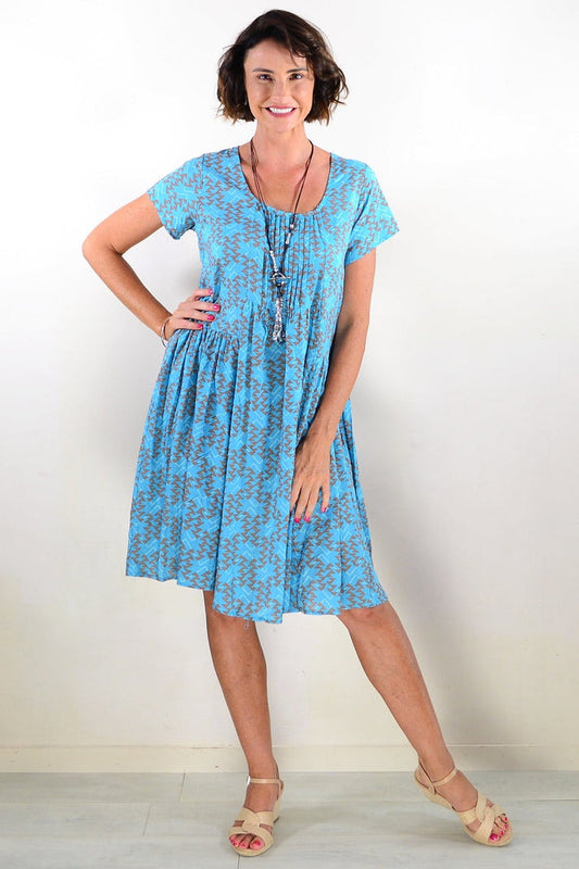 Hourglass Aqua Triangles pintuck pleats tunic dress with flowing fabric and intricate pleated details, styled for a casual elegant look.