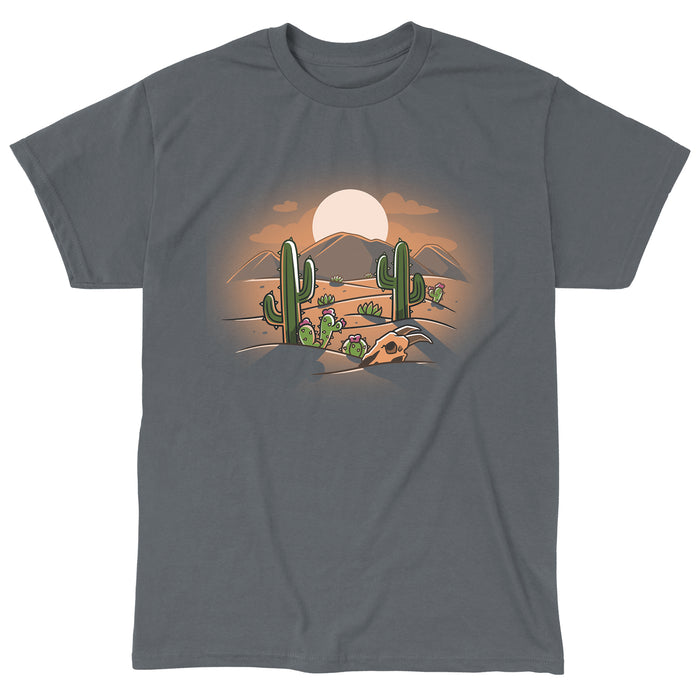 Classic Cotton T-shirt_TeeTurtle  Desert at Dusk charcoal gray t-shirt featuring a cartoon desert scene with cacti, a cow skull, and distant mountains under a stunning desert sunset.