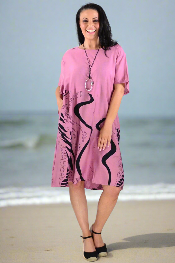 Dusty pink striped tunic dress by Sunshine, featuring a relaxed fit and casual style, shown on a hanger.