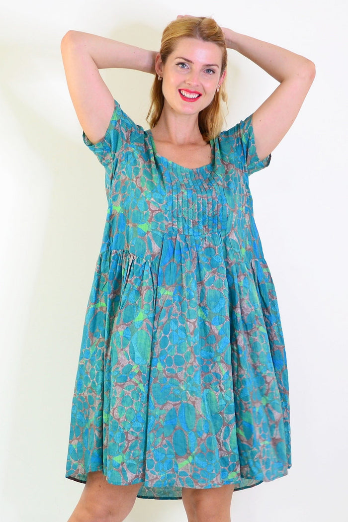 Emerald aqua abstract tunic dress by Wishstone, flowing fabric with vibrant pattern, front view highlighting stylish design.
