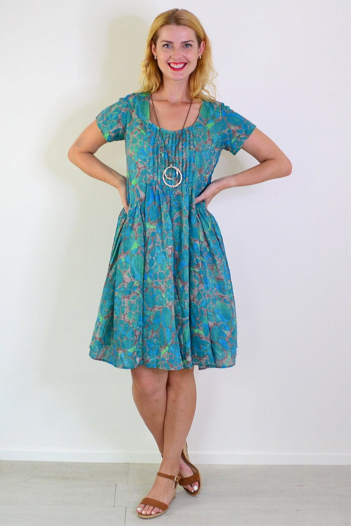 Emerald aqua abstract tunic dress by Wishstone, featuring a flowing design and vibrant pattern, displayed on a hanger.