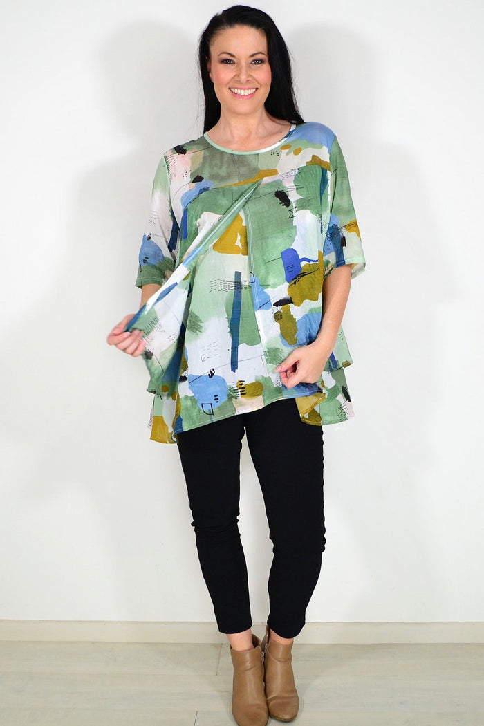 Green layered abstract tunic top by Whispers featuring flowing fabric and artistic pattern, ideal for casual or stylish wear.