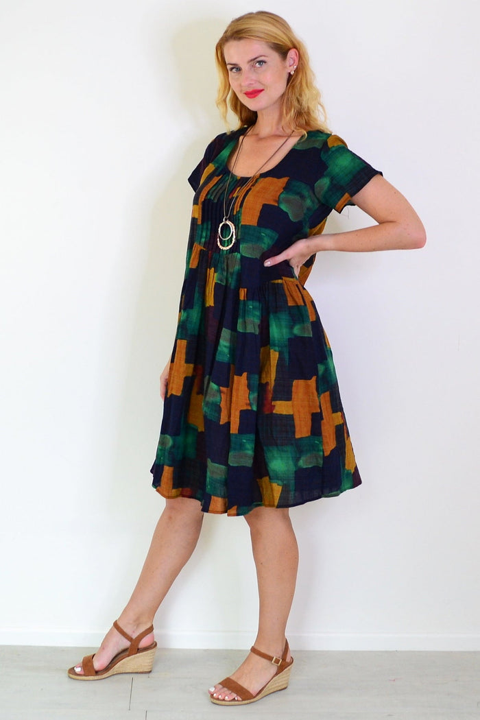 Mustard olive abstract tunic dress by Wishstone featuring a relaxed fit and artistic pattern, shown on a hanger.