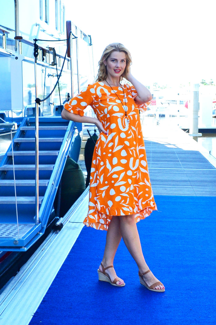 Orange and white spotted print summer tunic dress by New U Collection, lightweight fabric with a relaxed fit and stylish design.
