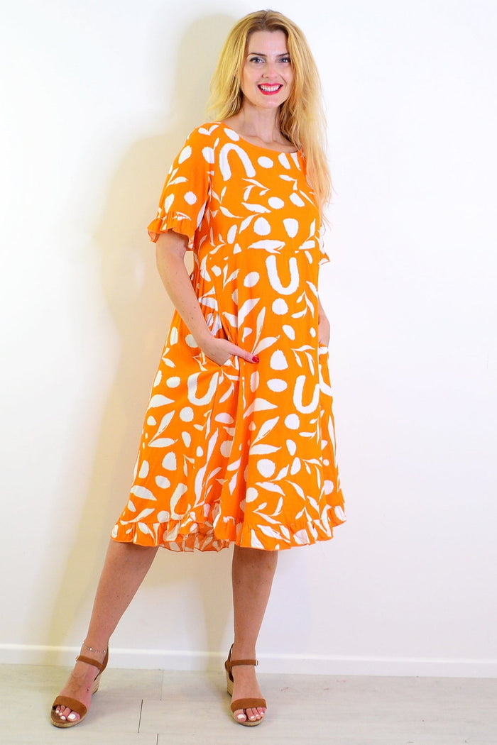 Orange and white spots print summer tunic dress by New U Collection, featuring a stylish, lightweight design perfect for warm weather.