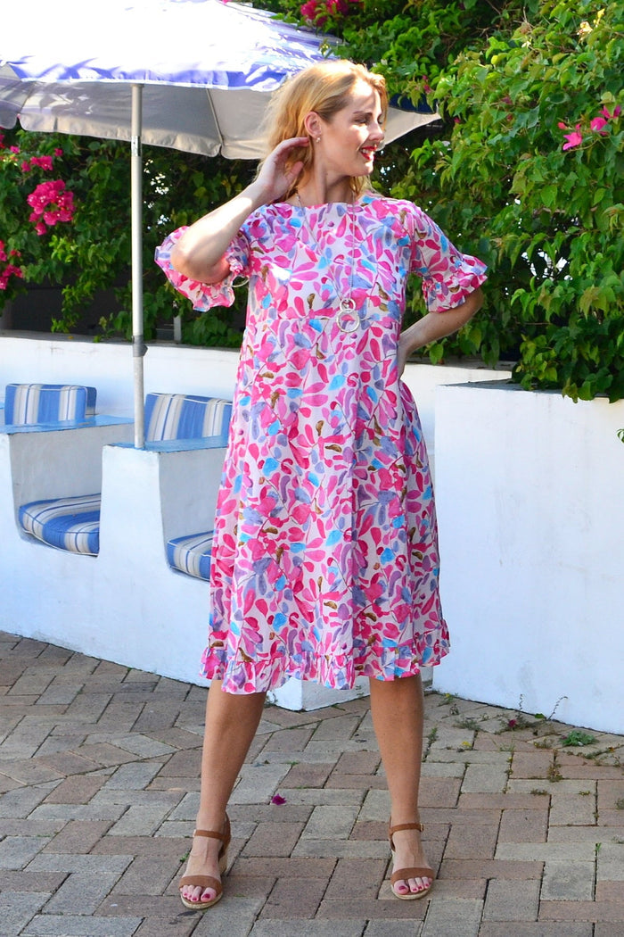 Pink and blue leaves print summer tunic dress by Hourglass, featuring a lightweight fabric and relaxed fit.
