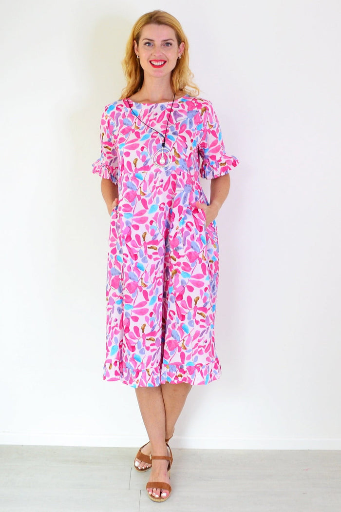 Pink and blue leaves print summer tunic dress by Hourglass with a flowy fabric and floral pattern.