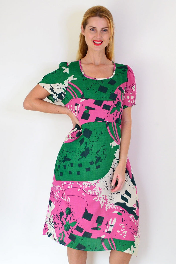 Pink and green paint splash tunic dress by Wishstone, casual tunics with vibrant artistic design, shown on a model.