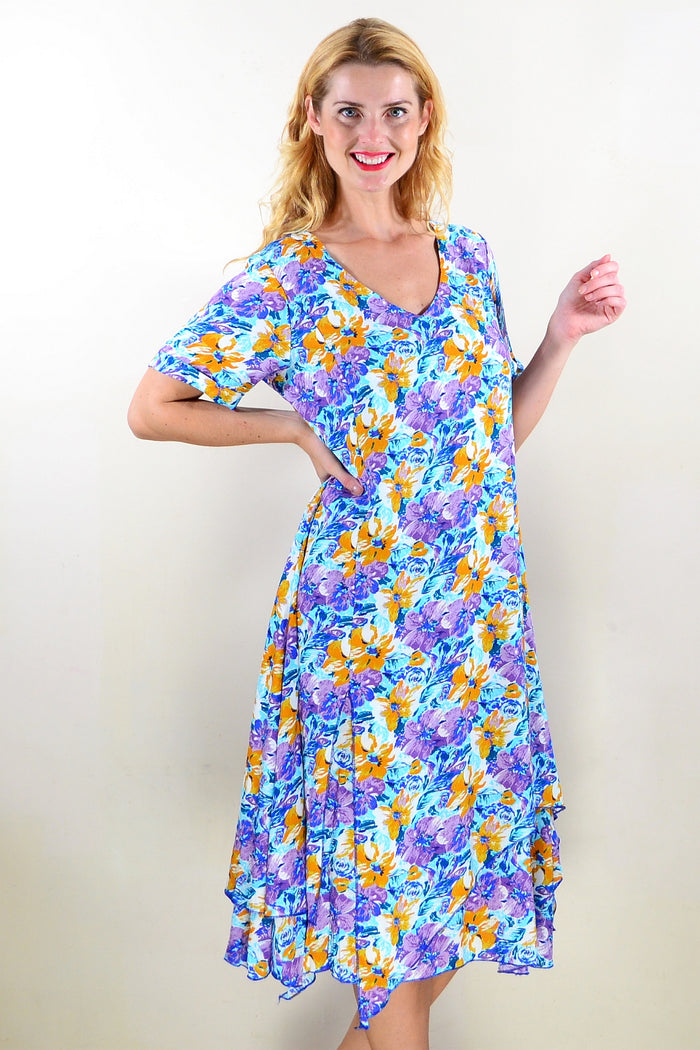 Purple mustard floral tunic dress by Missy Q featuring a relaxed fit with vibrant floral patterns and a comfortable neckline.