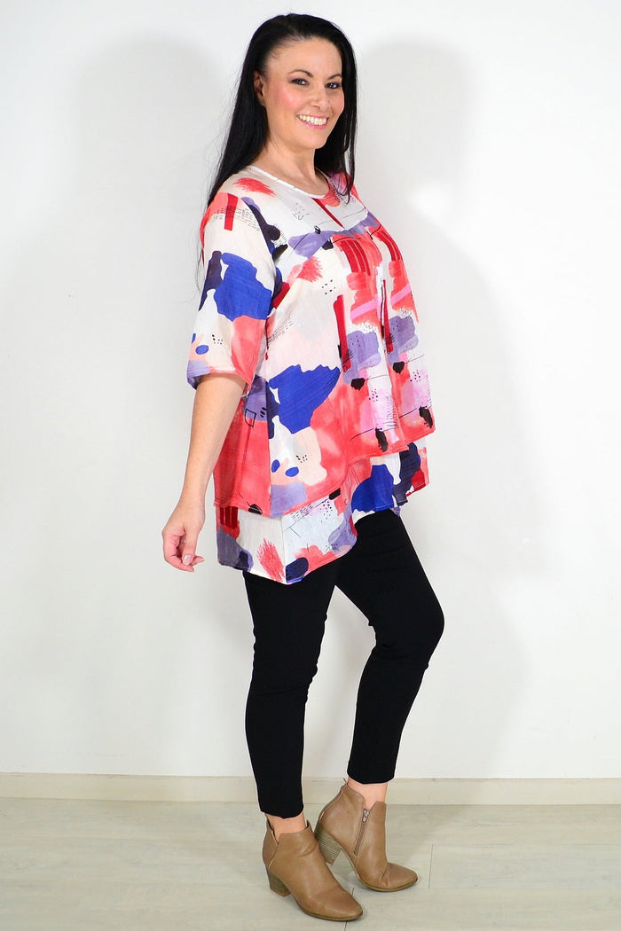 Red layered abstract tunic top by Whispers, featuring flowing fabric and artistic design, perfect for casual or stylish wear.
